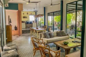 a living room with a couch and a table at Private pool villa with rice field sunset views in Phum Pobos +15 photos