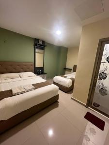 Ένα ή περισσότερα κρεβάτια σε δωμάτιο στο Enrich Hotel Setia Alam by uBook +15 φωτογραφίες
