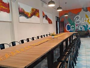 a long table in a room with chairs at Esemka Hotel and Convention Kotabumi in Kotabumi