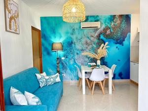 a living room with a blue couch and a table at Magagi in Favignana