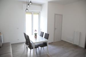 a white dining room with a table and chairs at Sognare in Puglia in Valenzano +9 photos