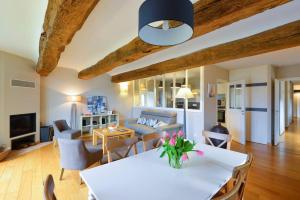 a living room with a white table and chairs at Manoir de Larmor in Vannes