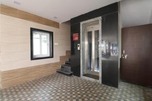 a hallway with a door and stairs in a building at HOTEL VALLABHA RESiDENCY in Rājahmundry