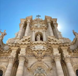 a tall building with a cross on top of it at Residenza Ponente in Syracuse