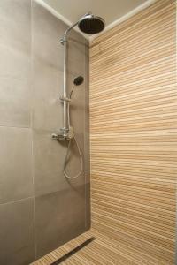 a shower with a shower head in a bathroom at Casa Anastasia in Pastida +23 photos