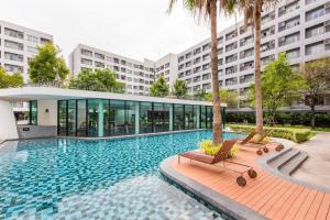 a swimming pool in front of a building at Elio Del Ray Studio walk to BTS in Bangkok