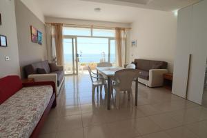 a living room with a table and a couch at Casa Nisea Modern Two-Level Home with Sea View in Santa Cesarea Terme in Santa Cesarea Terme