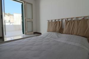 a bed in a room with a large window at Casa Nisea Modern Two-Level Home with Sea View in Santa Cesarea Terme in Santa Cesarea Terme