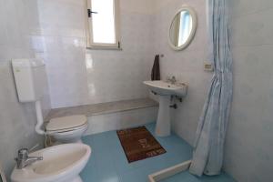 a bathroom with a toilet and a sink at Casa Nisea Modern Two-Level Home with Sea View in Santa Cesarea Terme in Santa Cesarea Terme