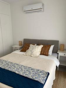 a bedroom with a large bed with two night stands at Blue Deja Blue Seaside Appartments in Bahçeli +21 photos