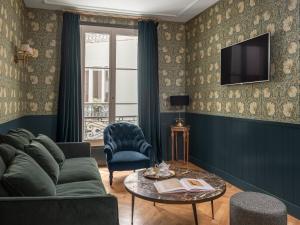 a living room with a couch and a table at Maison Malesherbes in Paris