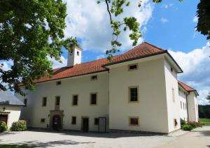 a large white building with a tower at Grad Tuštanj in Moravče