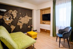 a living room with a map of the world on the wall at The QUARK Modern Designed 2BR Central Apartment in Craiova