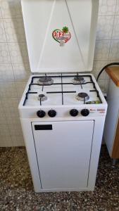 a white stove top oven sitting in a kitchen at Terrazza sul mare in Crotone +10 photos