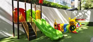 a childrens playground with a slide and a slideintend at Pooh Beach Resort & Spa in Jomtien Beach +89 photos