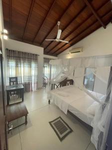 a bedroom with two bunk beds and a ceiling at Lucky 's place unawatuna in Unawatuna +58 photos
