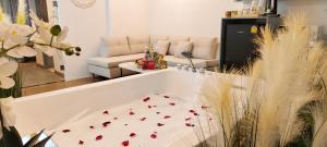 a bathroom with a tub with flowers on the floor at Pooh Beach Resort & Spa in Jomtien Beach