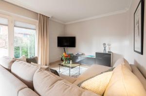 a living room with a couch and a tv at Haus Gorch Fock Strasse in Westerland