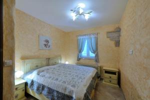 a bedroom with a bed and a chandelier at Vila Mila sa privatnim bazenom in Medulin +24 photos