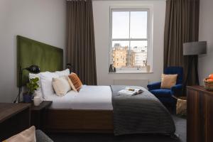 a hotel room with a bed and a window at Native Hyde Park in London