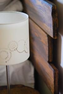 a white lamp sitting next to a wooden table at Manor Farm Stay in Sutton on Sea
