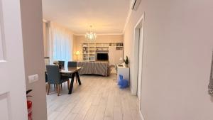 a dining room and living room with a table and chairs at Casa Mimì in Parma
