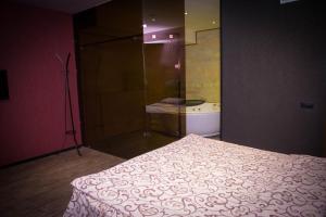 a bedroom with a bed and a glass shower at Palazzo Hotel in Yerevan