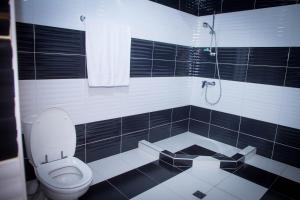 a black and white bathroom with a toilet and a shower at Palazzo Hotel in Yerevan +14 photos