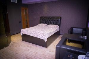 a bedroom with a bed and a couch at Palazzo Hotel in Yerevan