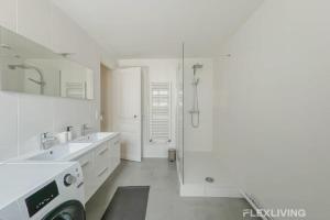 a white bathroom with two sinks and a shower at Flexliving - room - Turbigo in Paris +16 photos
