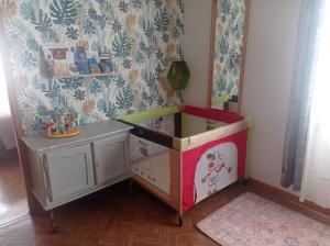 a toy room with a dresser and a mirror at Appartement au rez -de -chaussée maison individuelle in Louvigny