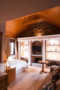 a bedroom with a bed and a stone fireplace at Vega de la Reina in Jaén