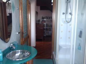 a bathroom with a sink and a shower at B&B Corallo in Sassari