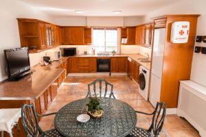 a kitchen with a table and chairs and a refrigerator at Vega de la Reina in Jaén +104 photos