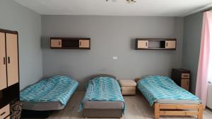a room with two mattresses and two beds in it at Parkowe Ranczo in Poraj