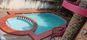 a small swimming pool with a letter k painted on it at Paradise Castle Villa in Auroville