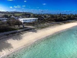an aerial view of a beach with a building in the background at Hotel Yagajiso in Nago