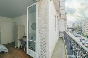 a balcony with a view of a city at Flexliving - room - Paris 15 in Paris