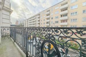 a black iron fence in front of a building at Flexliving - room - Paris 15 in Paris