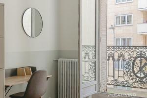 a room with a chair and a mirror and a window at Flexliving - room - Paris 15 in Paris