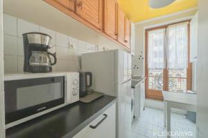 a kitchen with a microwave and a refrigerator at Flexliving - room - Paris 15 in Paris
