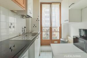 a small kitchen with a sink and a window at Flexliving - room - Paris 15 in Paris +31 photos