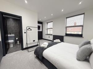 a bedroom with a large bed and a bathroom at Santi House in Boston