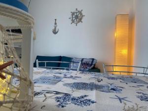 a bedroom with a bed with a blue and white blanket at Casa Orimar 419 in Badesi +23 photos