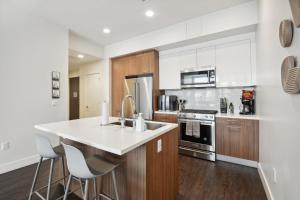 a kitchen with a white counter top and wooden cabinets at 2880 Japandi Minimalism at Espadin in Denver
