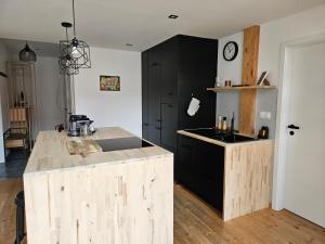a kitchen with a counter and a black cabinet at spacious modern LOFT, 2 bedrooms, 95m2, free parking in Bratislava