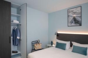 a hotel room with a bed and a closet at Best Western Alba in Nice +104 photos