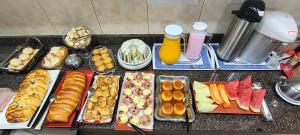 a table topped with lots of different types of food at Hotel Vila Solar in Limeira