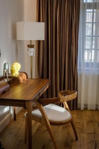 a room with a table and a chair and a lamp at Villa The Boutique Cappadocia in Urgup