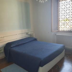 Кровать или кровати в номере La Casa Del Giardino Degli Olivi